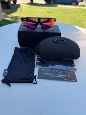 Oakley Black Frame Sunglasses with Pink-Orange Iridium Lens